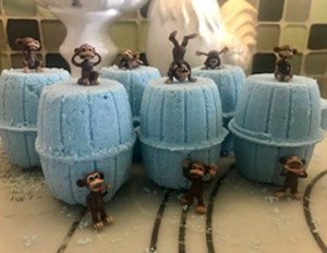 Barrel bath bomb with toy monkey inside